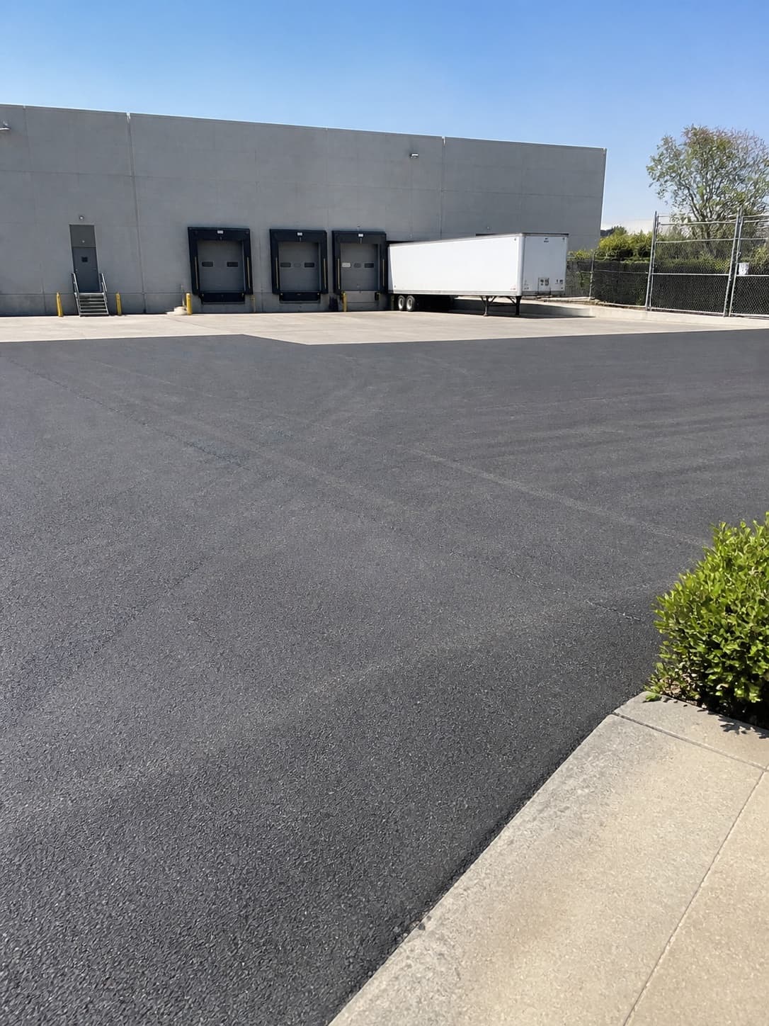 Illustrative iPhone-style view of a freshly paved Southern California warehouse truck court